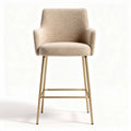 Upholstered bar height stool with gold metal legs and cream fabric finish